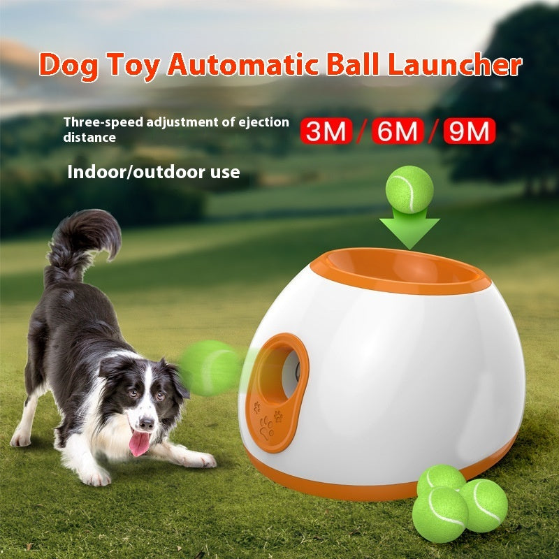 An advertisement image showing a dog toy automatic ball launcher. A dog is depicted playing with the ball launcher, which is in mid-action of launching a ball.