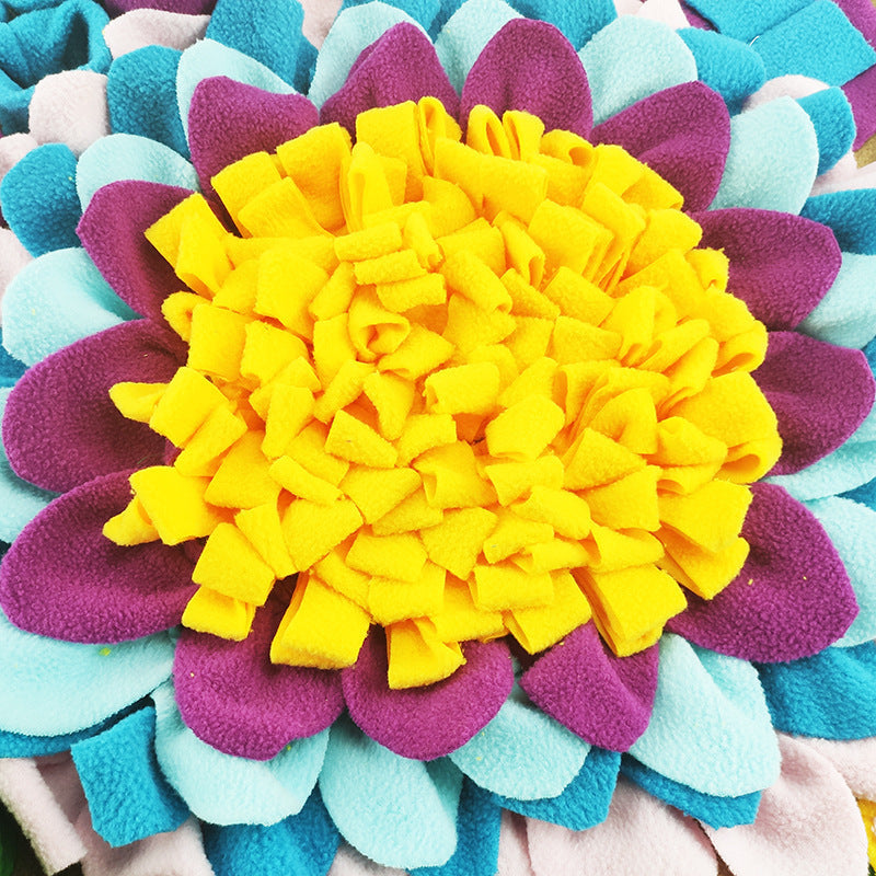 A colorful snuffle mat for dogs designed to look like a flower