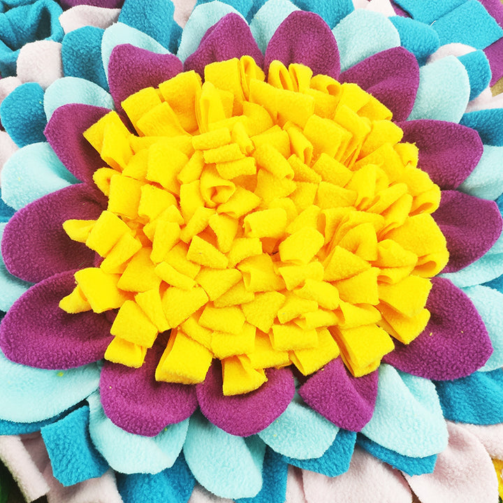A colorful snuffle mat for dogs designed to look like a flower