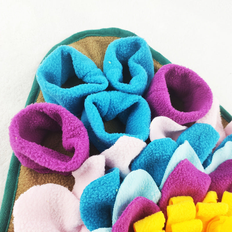 A colorful snuffle mat for dogs designed with multiple pockets and fabric folds to store treats.