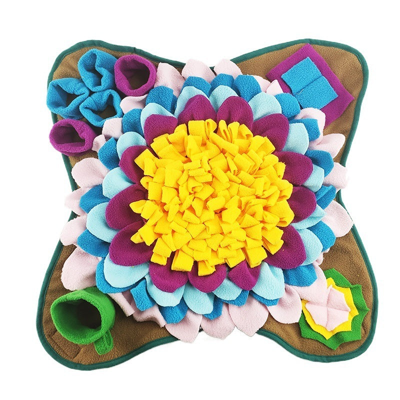 A colorful snuffle mat for dogs designed to look like a flower with multiple pockets and fabric folds to store treats.