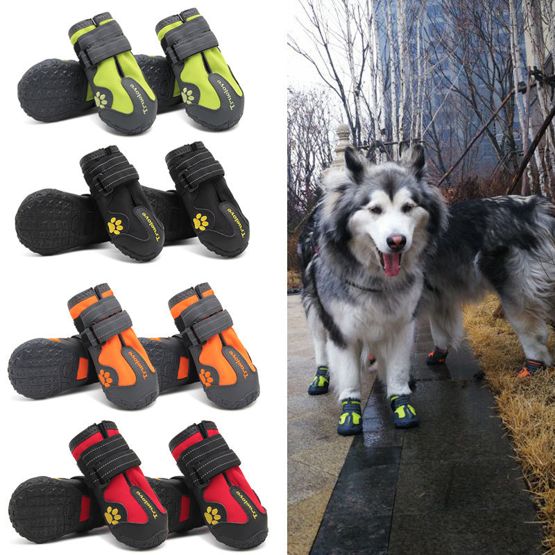 Set of dog boots in black, orange, and red with a photo of dogs wearing them outdoors.