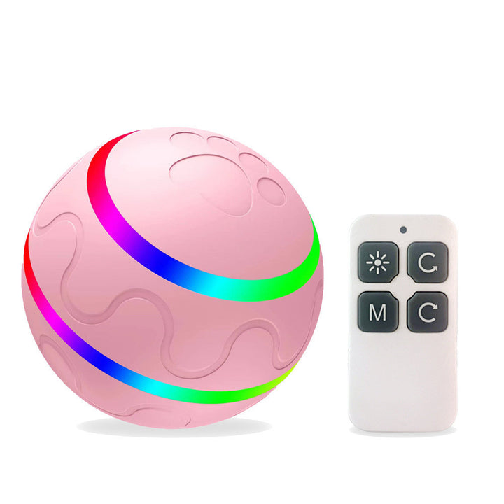 Pink ball with colorful light ring and remote control on a white background