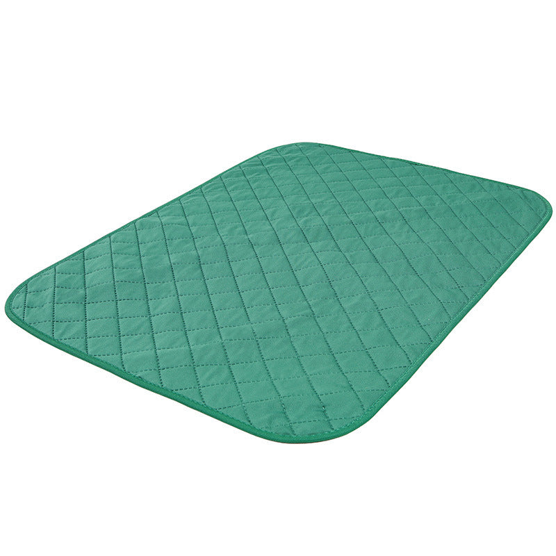 Green quilted mat on a white background