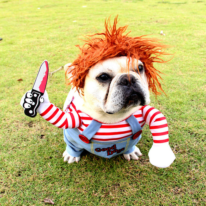Dog in a costume with red hair, striped shirt, and overalls on grass