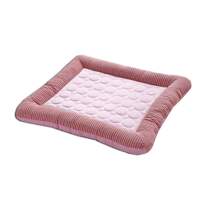 Pink pet bed with quilted surface on a white background