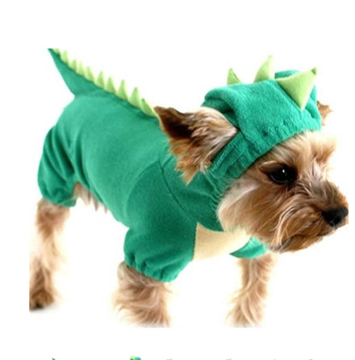 Dog wearing a green dinosaur costume on a white background