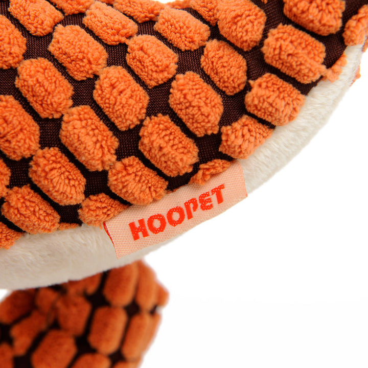 Close-up of a textured orange and brown dog toy with 'HOOPET' branding.