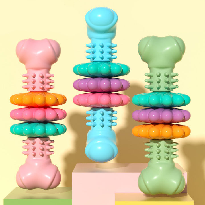 Colorful stackable toy with various shapes and textures on a light yellow background