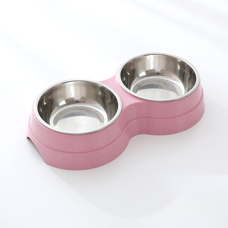 Pink pet bowl with two stainless steel compartments on a white background