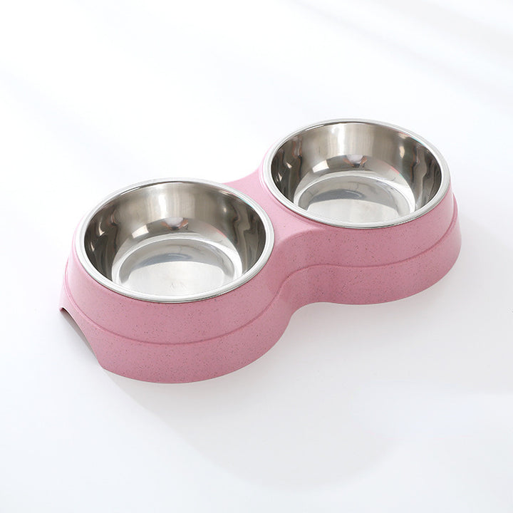 Pink pet bowl with two stainless steel compartments on a white background