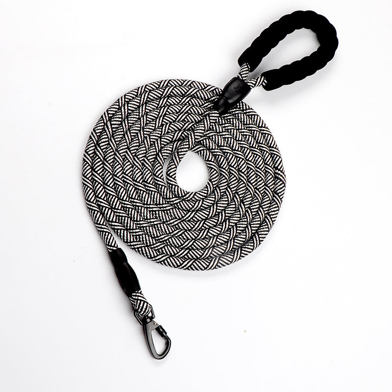 Black and white braided dog leash with carabiner on a white background