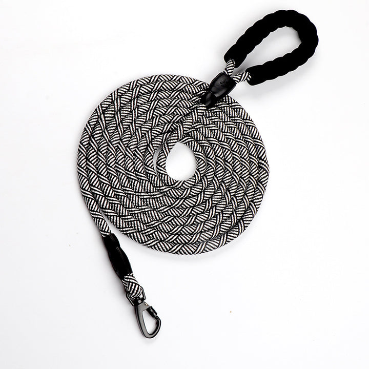 Black and white braided dog leash with carabiner on a white background