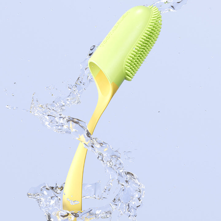 Green and yellow pet tooth brush with water splashes on a light blue background