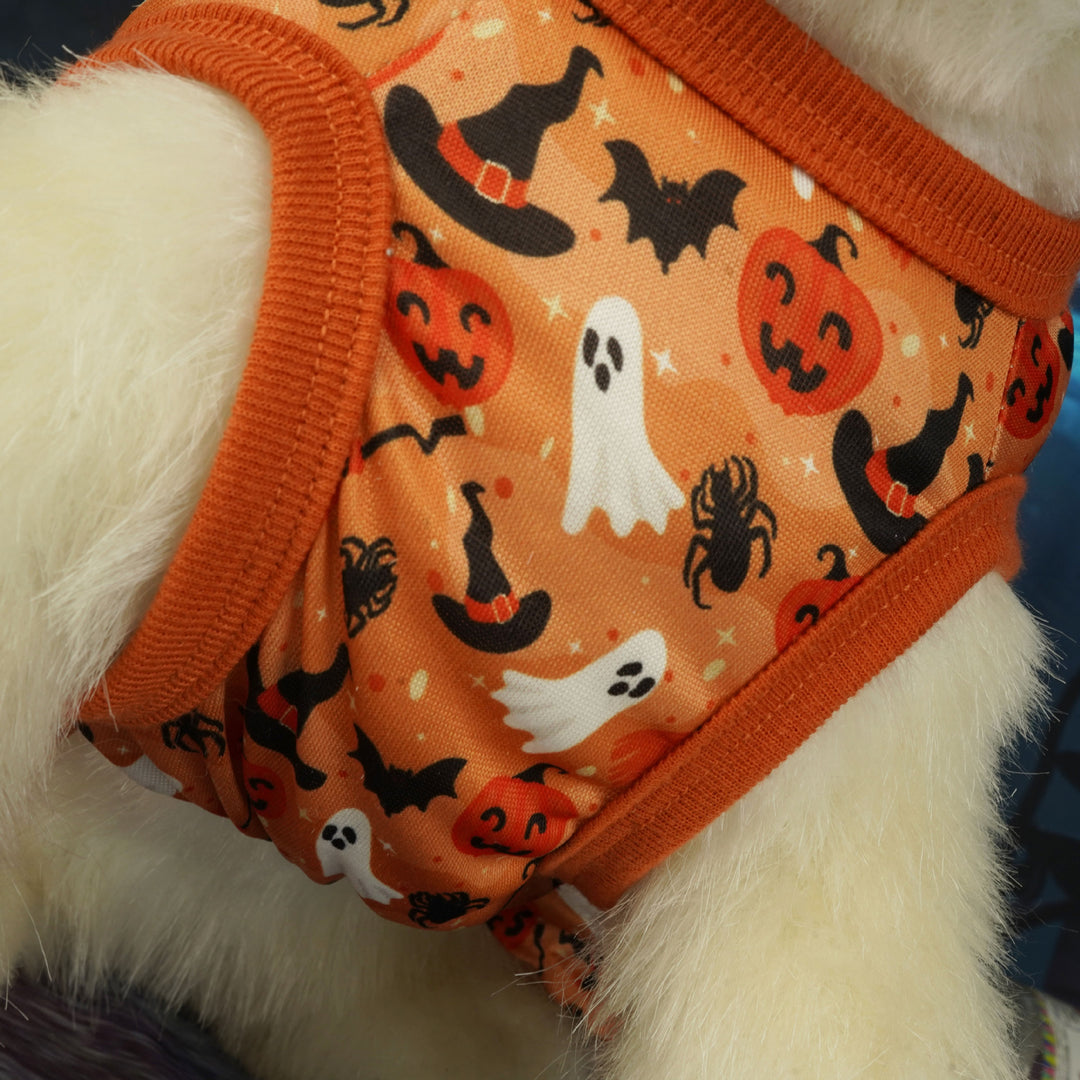 Halloween-themed dog dress with pumpkins, ghosts, and bats on an orange background.
