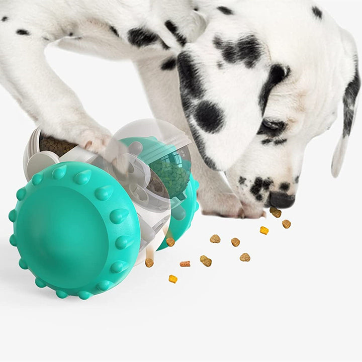 Teal dog toy with food dispensing mechanism next to a Dalmatian dog.