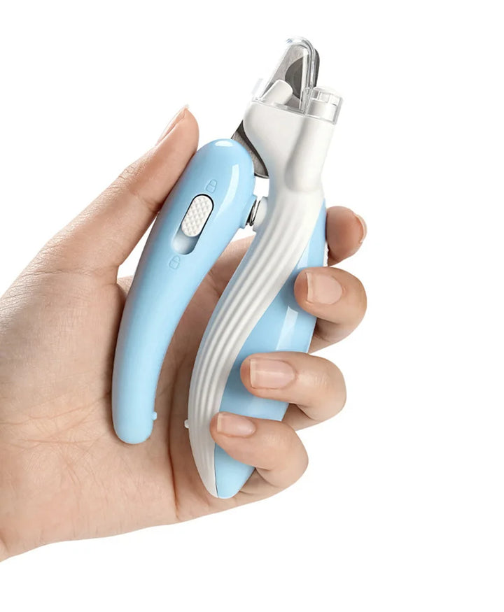Hand holding a blue and white pet nail clipper against a white background