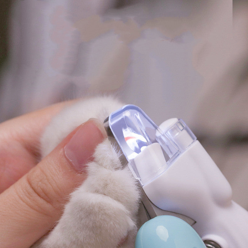 Pet nail clipper being used on a cat's paw with a blurred background