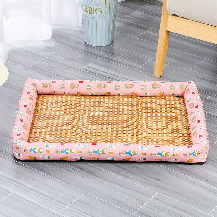 Pet bed with wicker design and pink border on a gray floor.