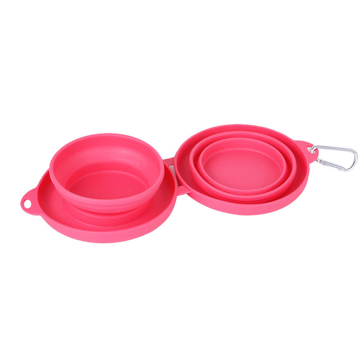 Pink collapsible dog bowls with carrying handle on a white background