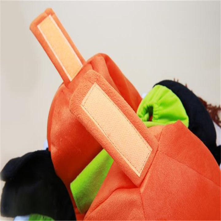 Close-up of a plush toy resembling a character from a popular video game, with a focus on the orange item.