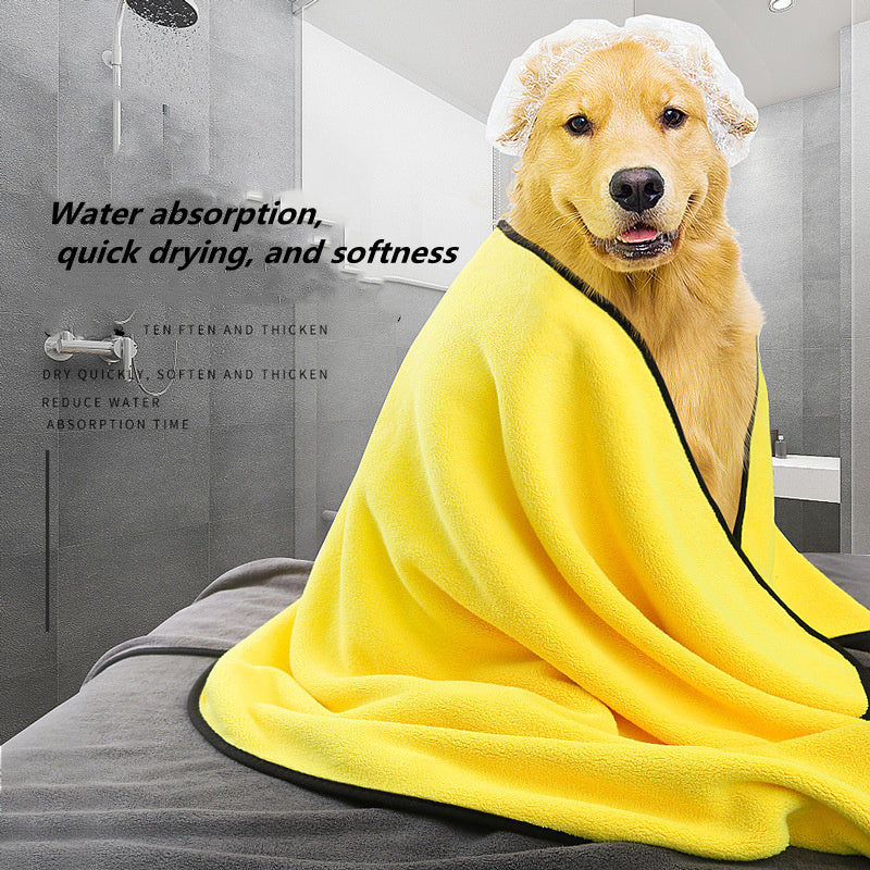 Dog wrapped in a yellow towel in a bathroom setting