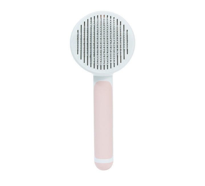 White and pink pet grooming brush on a white background