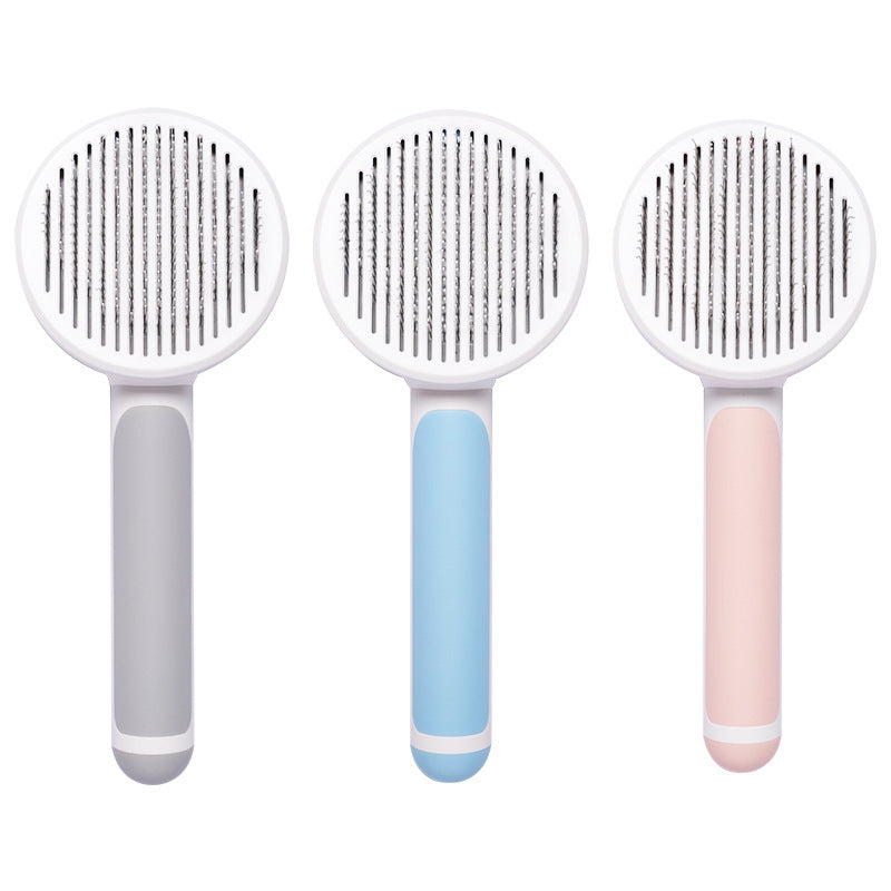 Three pet grooming brushes with different handle colors on a white background