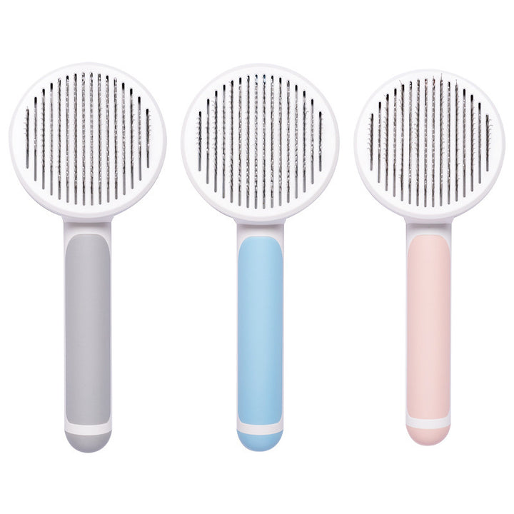 Three pet grooming brushes with different handle colors on a white background