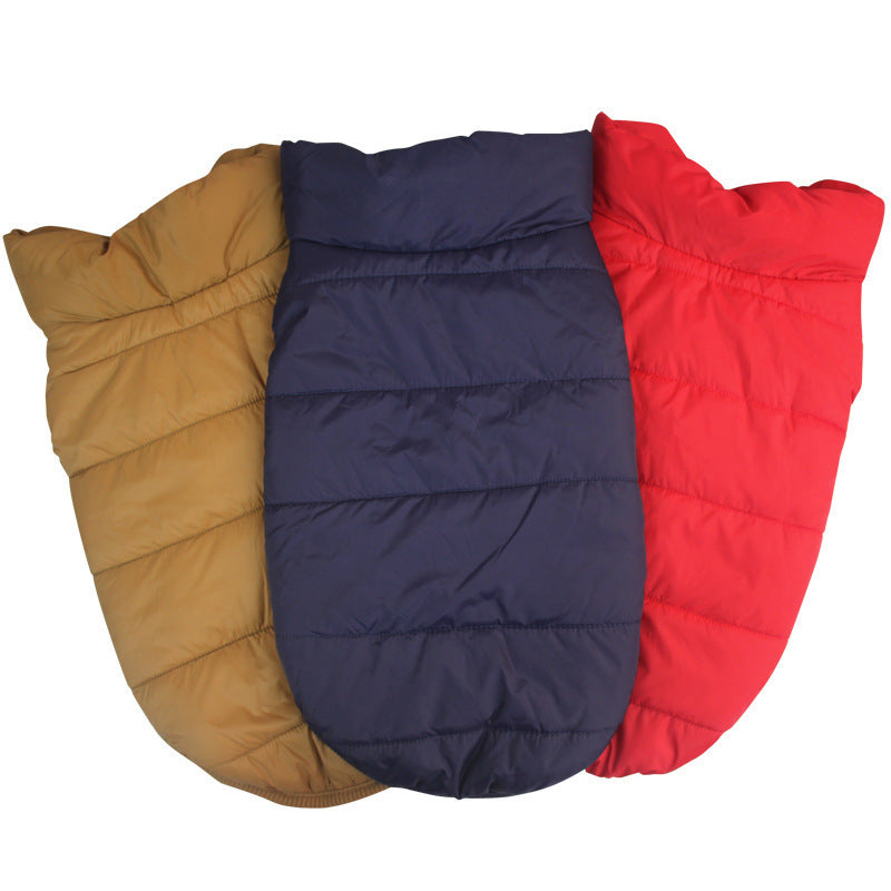 Three puffer dog coats in gold, navy, and red on a white background