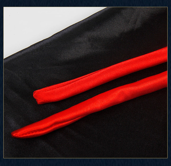 Two red ribbons on a black fabric background