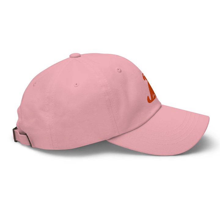 Pink baseball cap with a dog logo on a white background