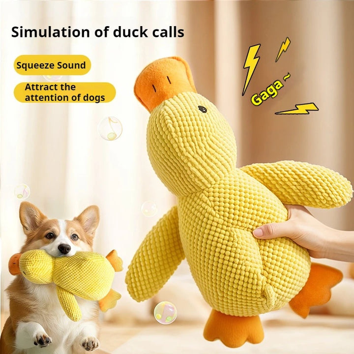 Yellow duck-shaped toy with a dog playing with it, on a light background.