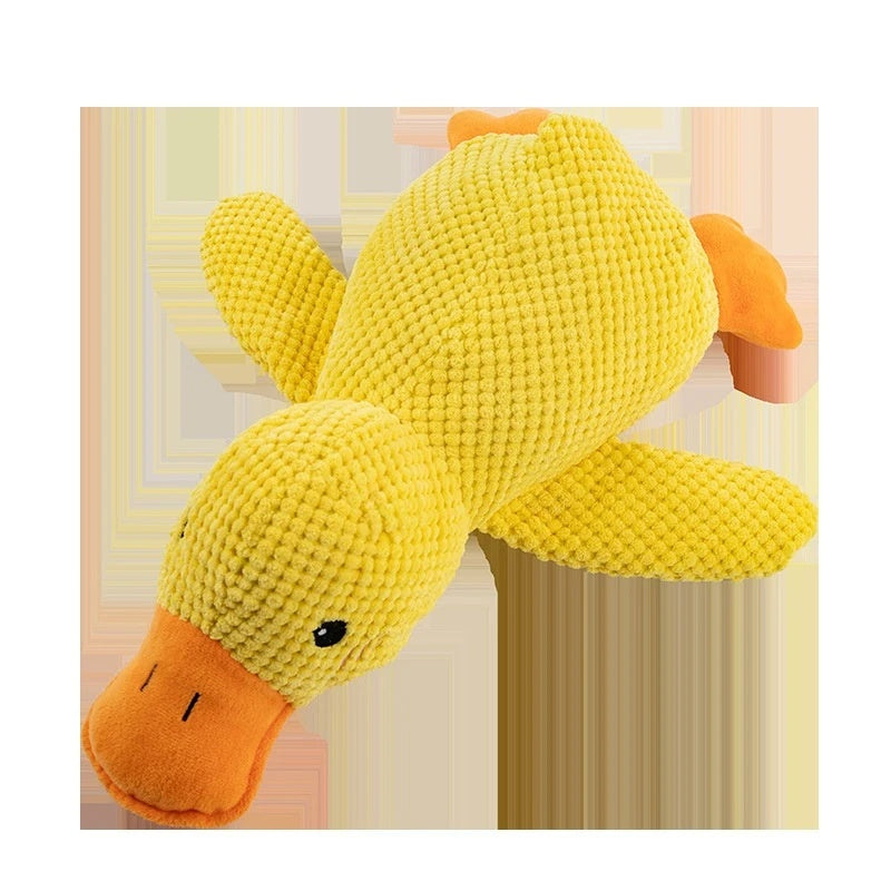Yellow plush duck toy on a striped background