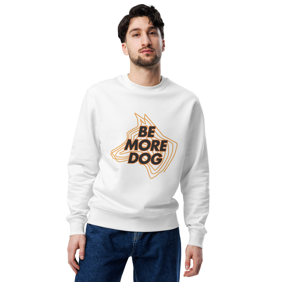 Person wearing a white sweatshirt with 'BE MORE DOG' text and graphic design on a white background
