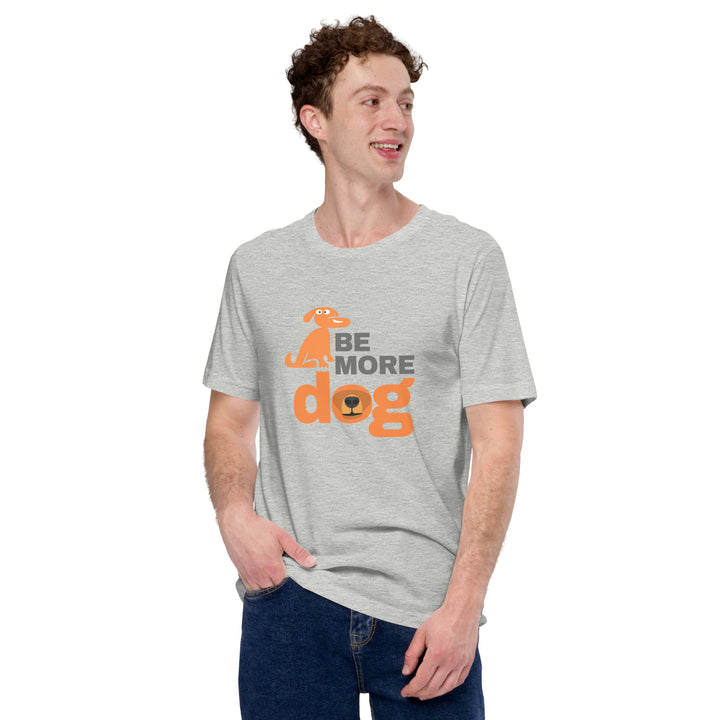 Person wearing a gray t-shirt with 'Be More Dog' text and graphic on a white background