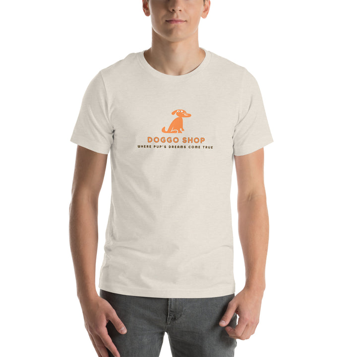 Person wearing a dust colored t-shirt with doggo shop logo on a white background