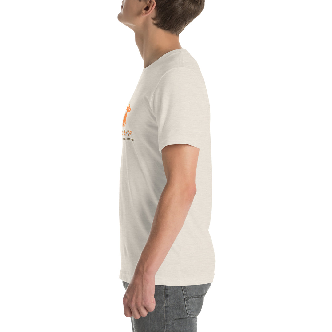 Person wearing a dust colored t-shirt with a logo on a white background