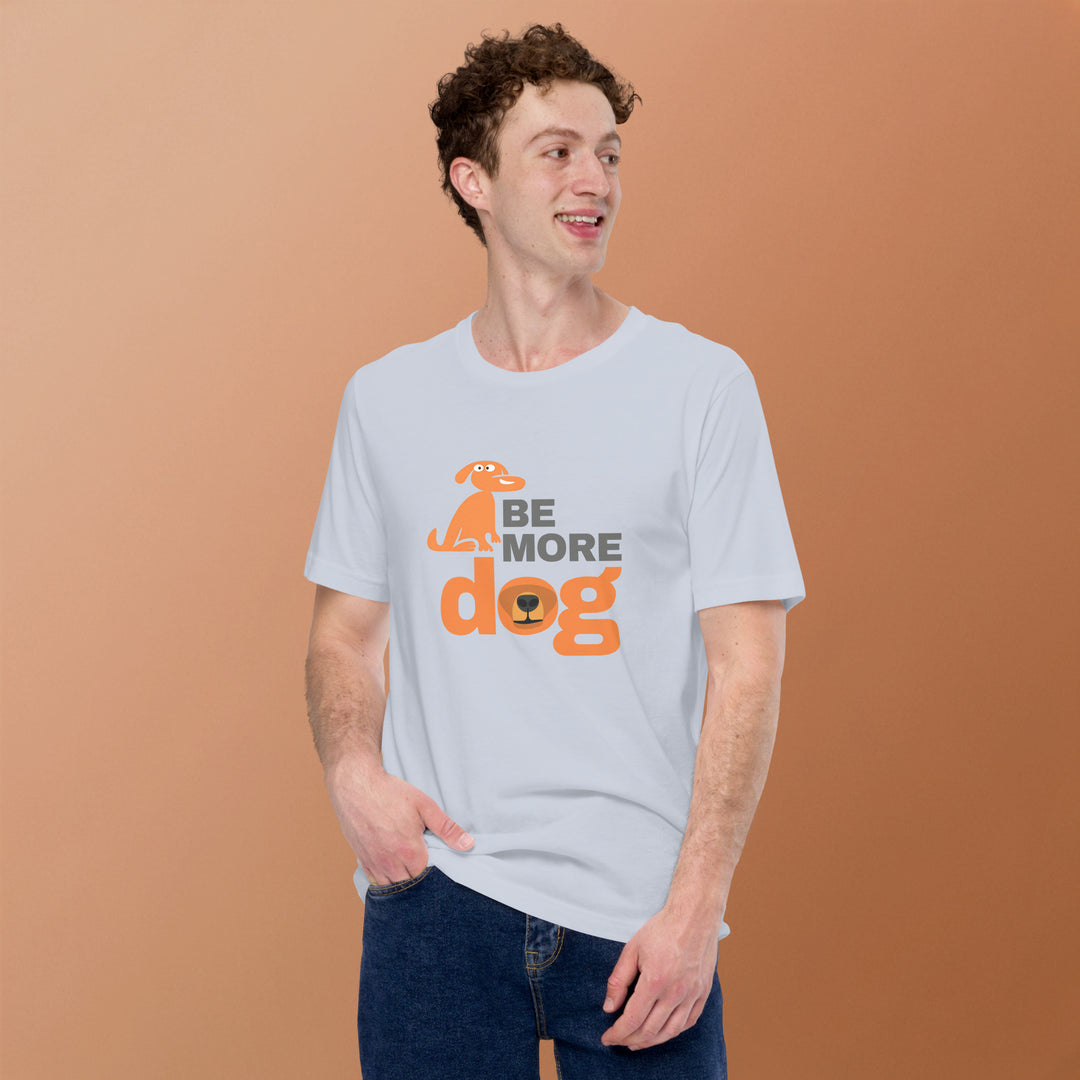 Man wearing a white t-shirt with 'Be More Dog' text and graphic on a brown background