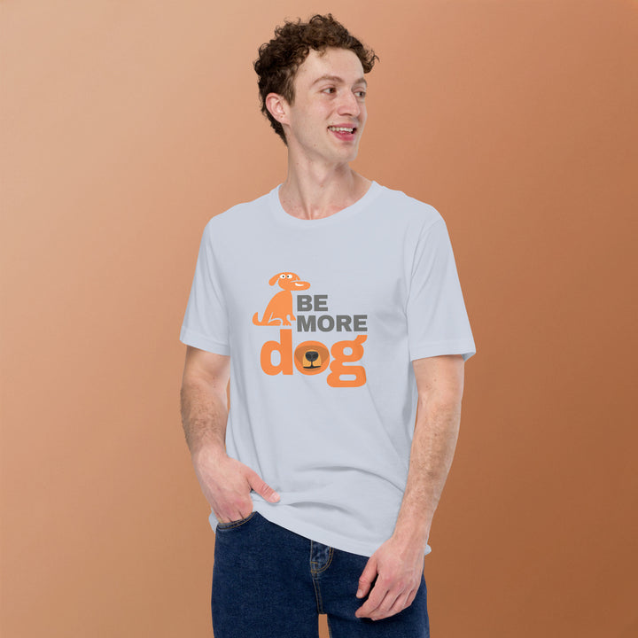 Man wearing a white t-shirt with 'Be More Dog' text and graphic on a brown background