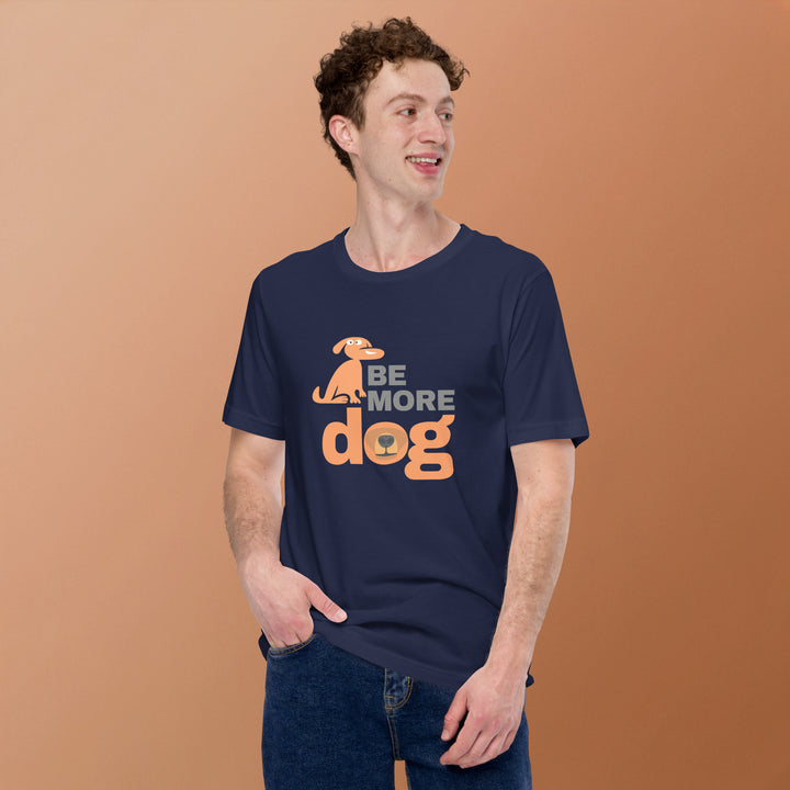 Man wearing a navy blue t-shirt with 'Be More Dog' text and graphic on a brown background