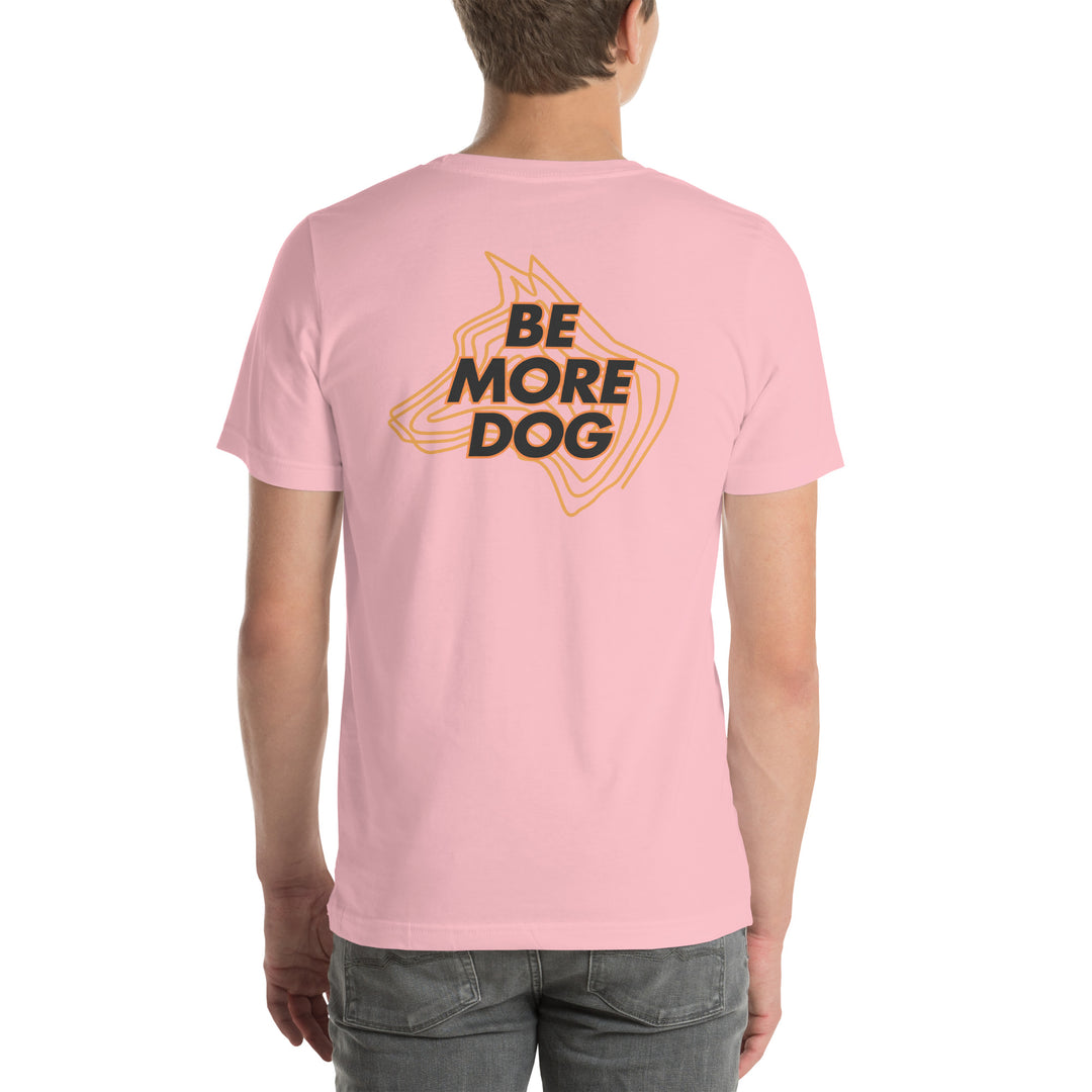 Person wearing a pink t-shirt with 'Be More Dog' text on the back
