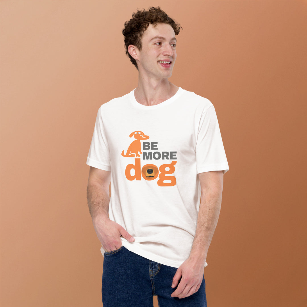 Man wearing a white t-shirt with 'Be More Dog' text and graphic on a brown background