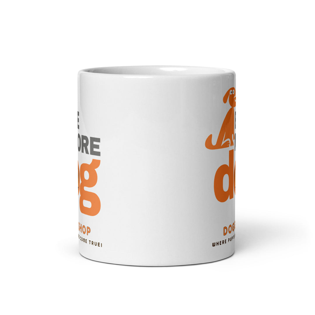 White ceramic glossy mug with 'be more dog print' on a white background