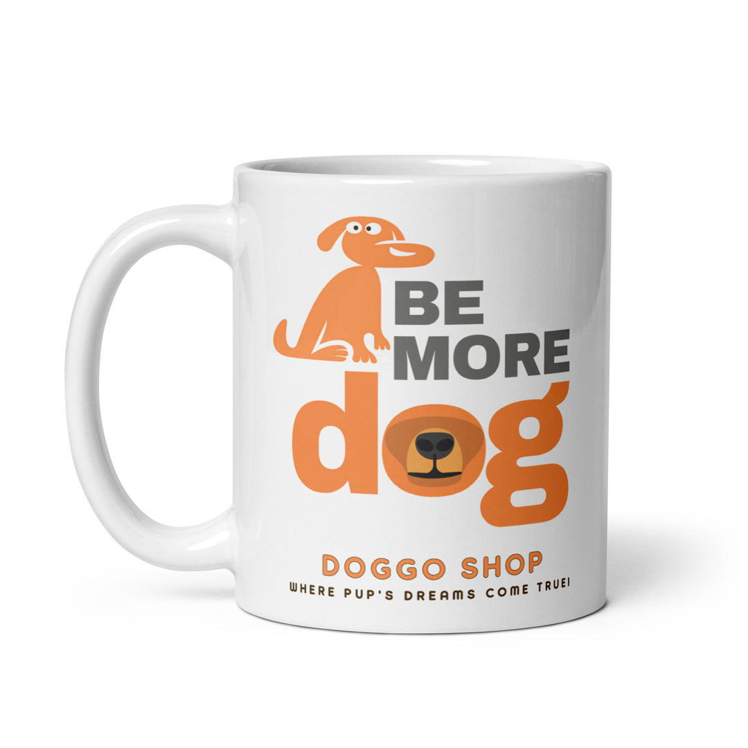 White ceramic glossy mug with 'be more dog print' on a white background