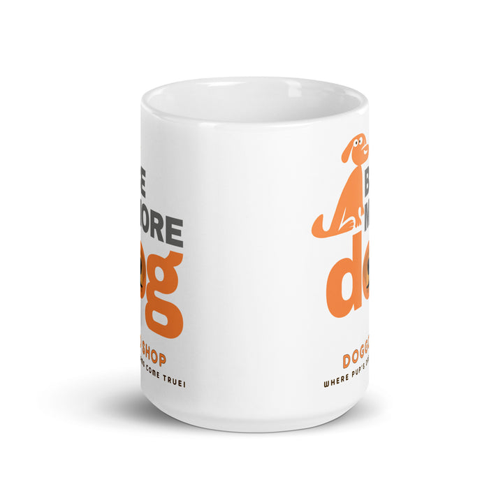 White ceramic glossy mug with 'be more dog print' on a white background