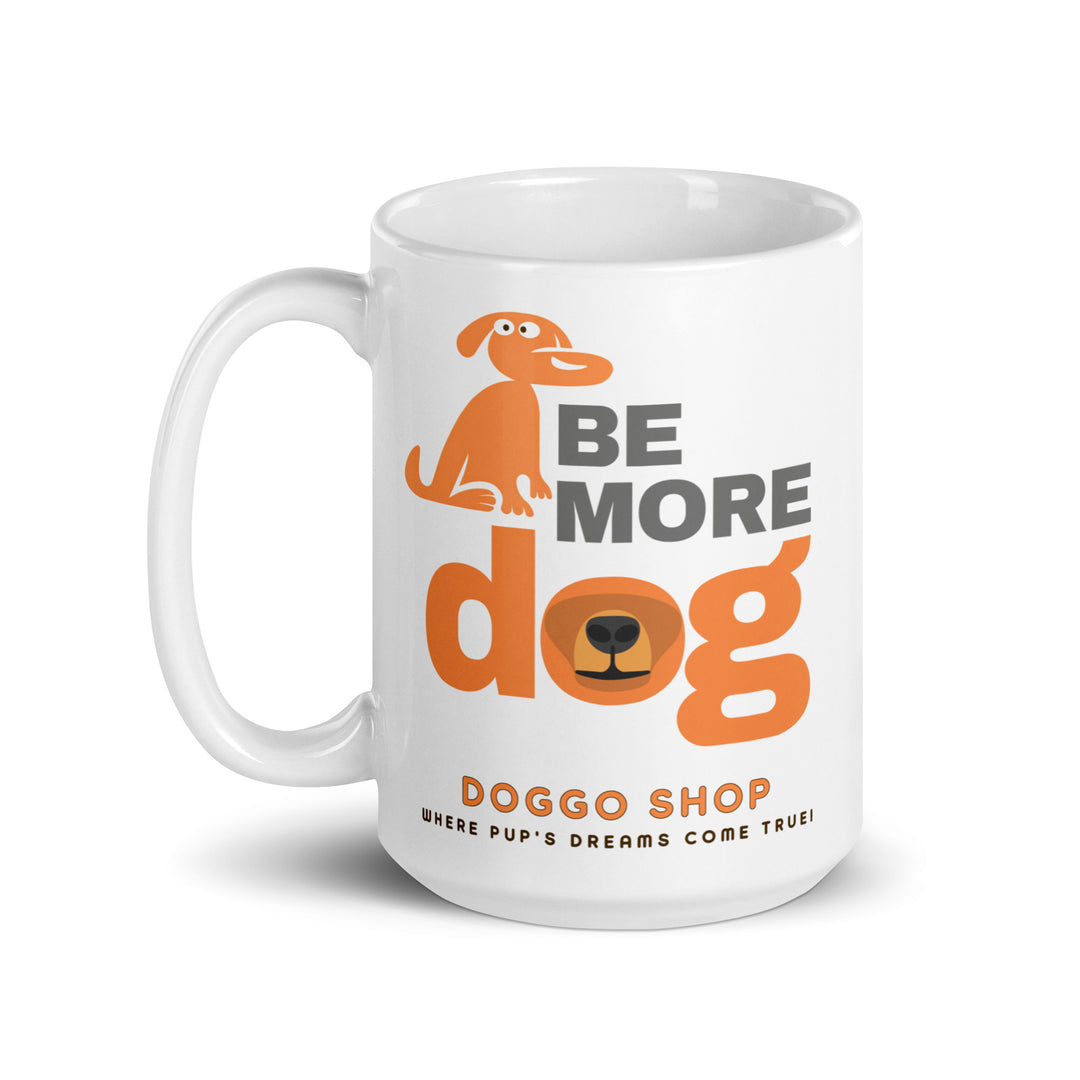White ceramic glossy mug with 'be more dog print' on a white background