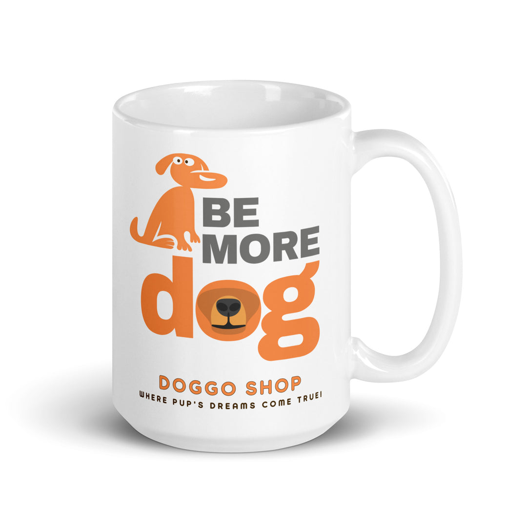 White ceramic glossy mug with 'be more dog print' on a white background