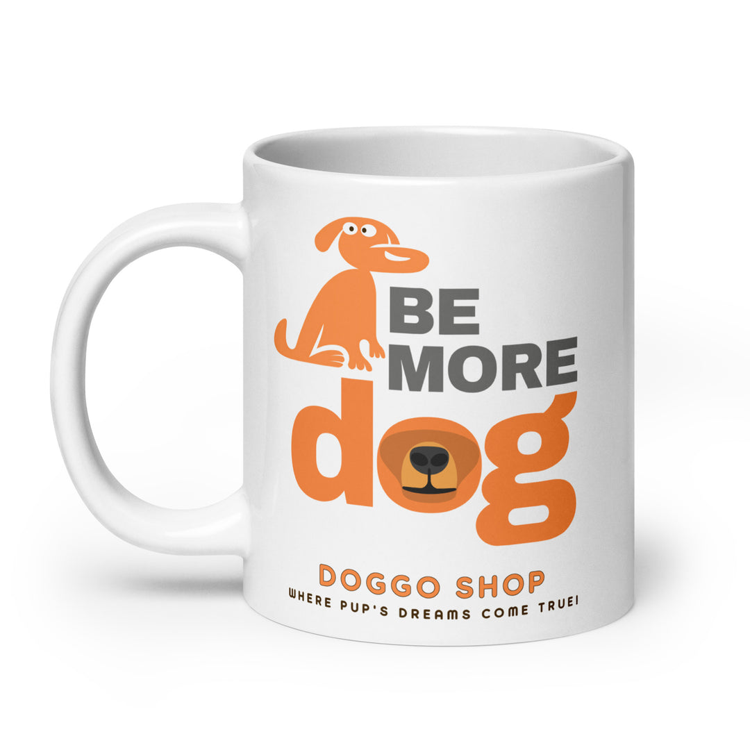 White ceramic glossy mug with 'be more dog print' on a white background