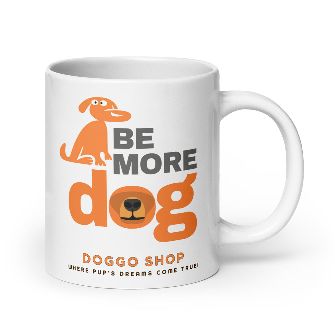 White ceramic glossy mug with 'be more dog print' on a white background